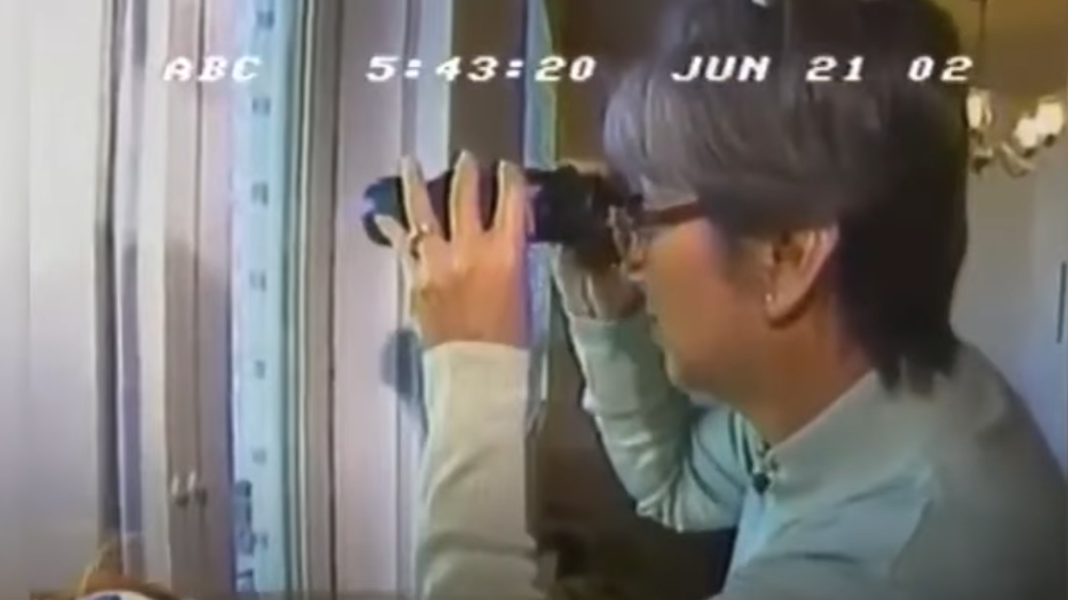 ABC News footage of Maria looking through binoculars - witness to the Dancing Israelis